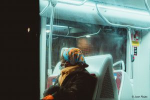 Woman wearing a face mask while riding a bus in Toronto
